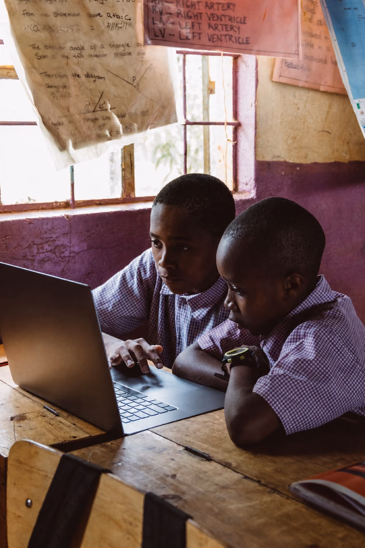 Students learning together with a laptop in class
