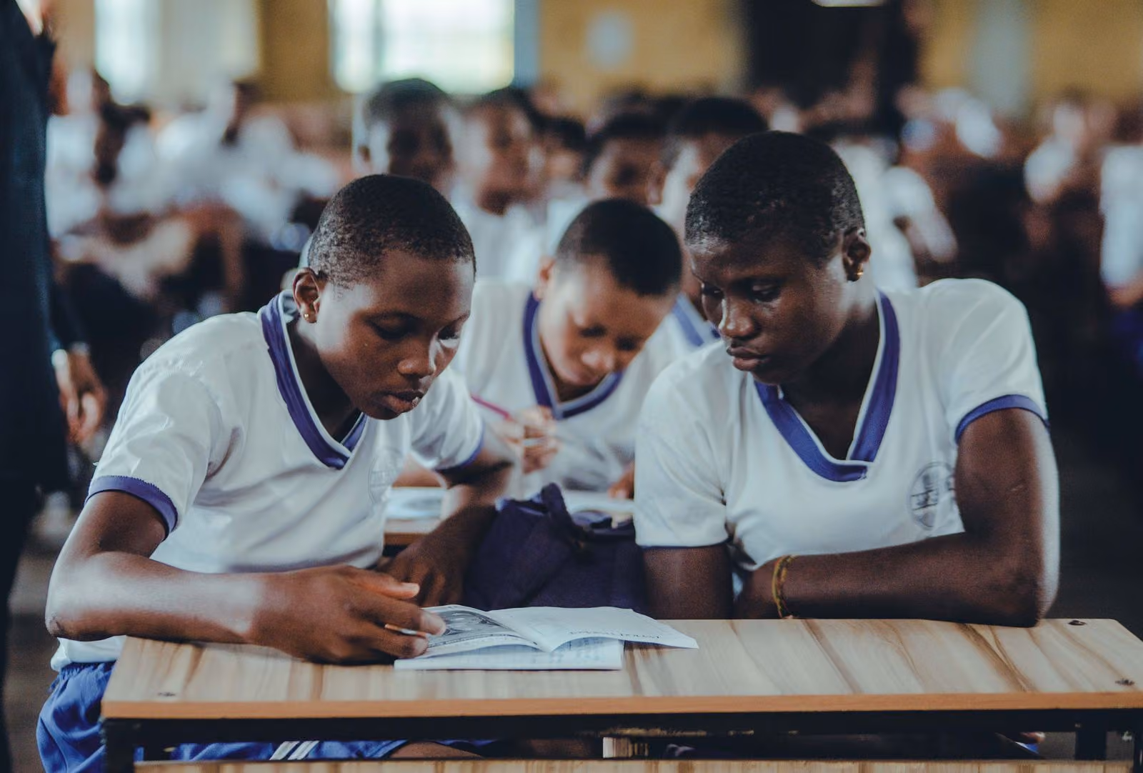 Secondary school students studying together in uniform